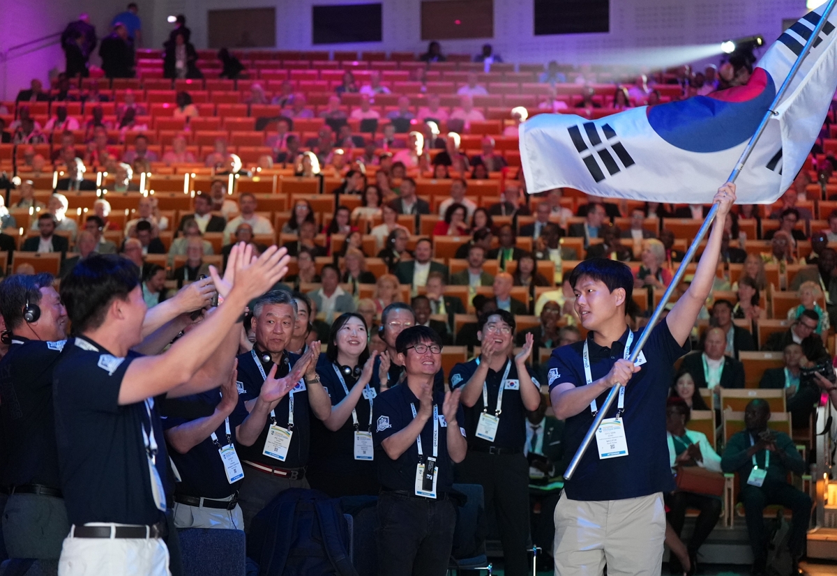 스웨덴 스톡홀름에서 개최된 2025년 세계신협 컨퍼런스 개막식에서 한국신협 대표단이 참석해 태극기를 흔들고 있다.